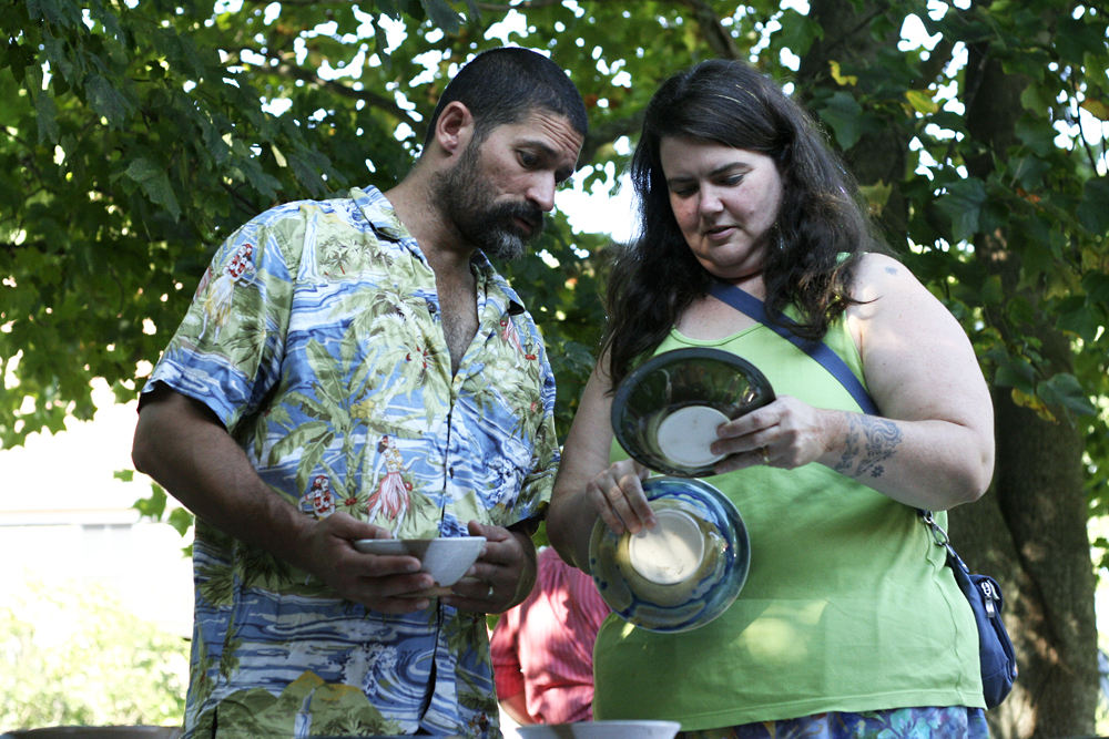 couple looks at pottery