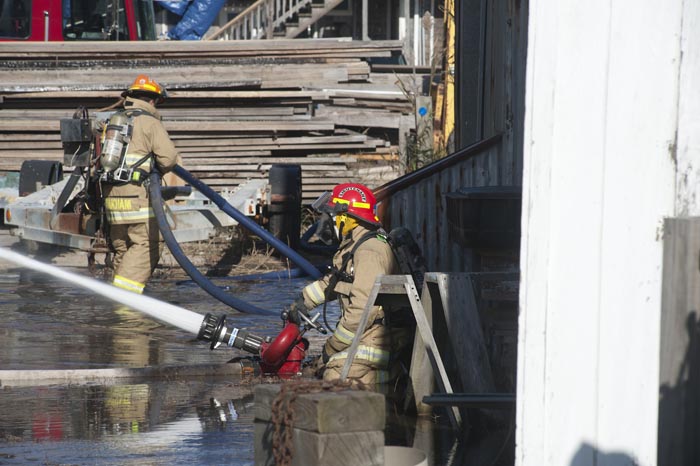 Fire Maciel Marine boat shed fire fighters hose