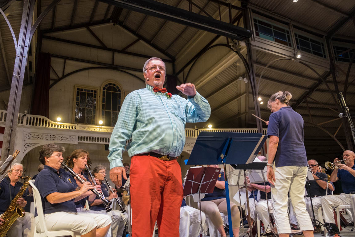 Robert Cleasby directs the singing of patriotic songs.