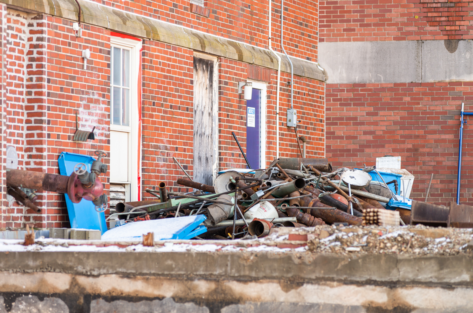 Piles of debris are organized in the demolition areas.