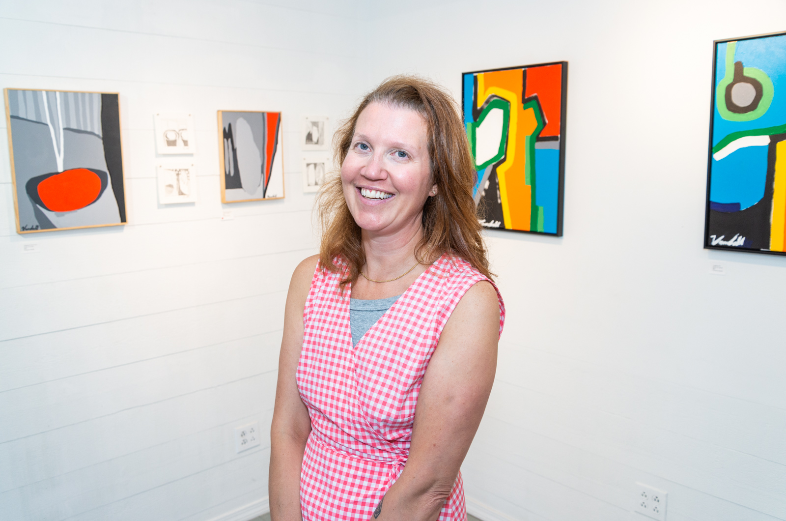 Cheyanne Vandall with her paintings at The Workshop Gallery in Vineyard Haven.