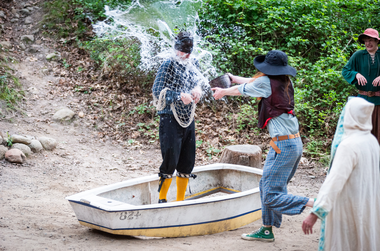 Augie Padua (Sir Toby Belch) douses Xavier Powers (Malvolio) to convince him he is at sea.