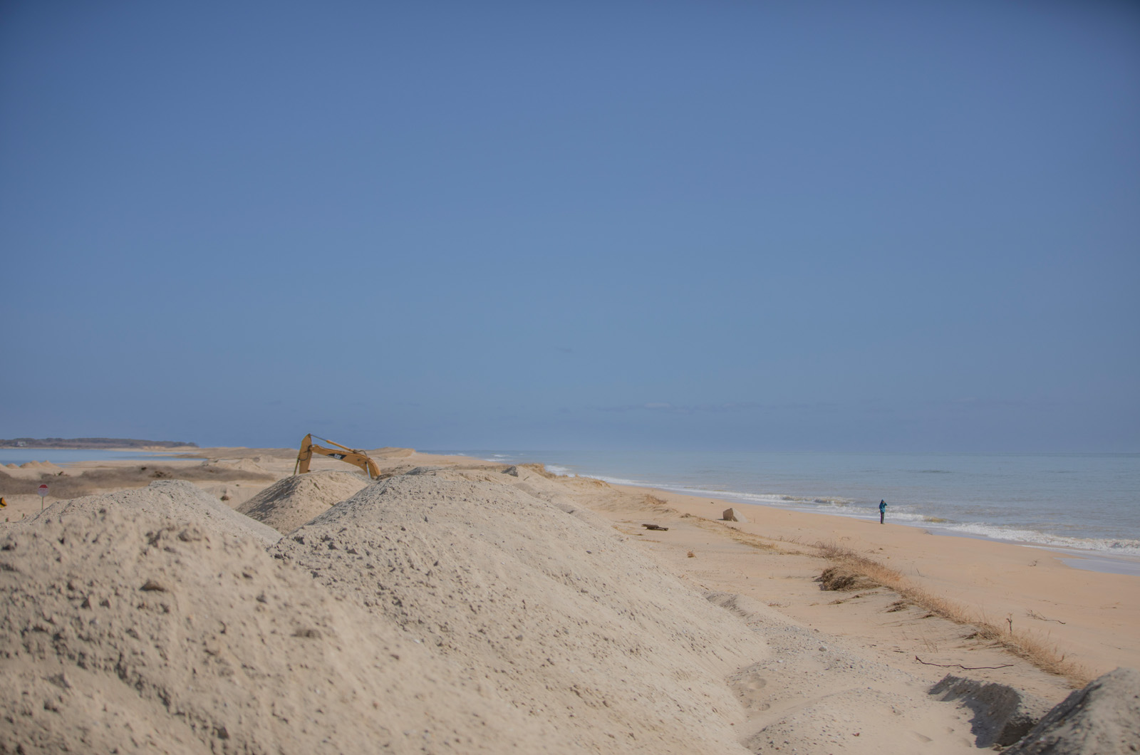 An excavator moves sand at Norton Point.