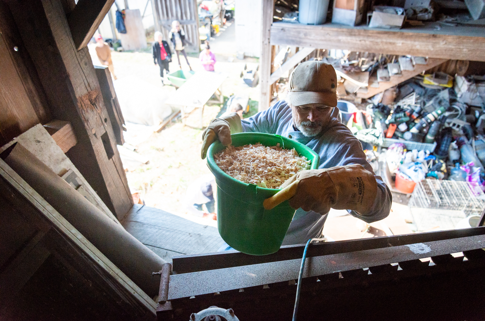 Andrew Woodruff carrying wood shavings into the loft.