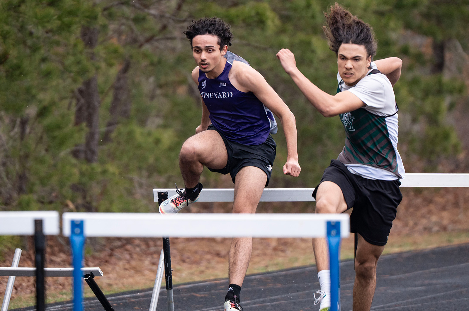 A Vineyard athlete clears a hurdle.