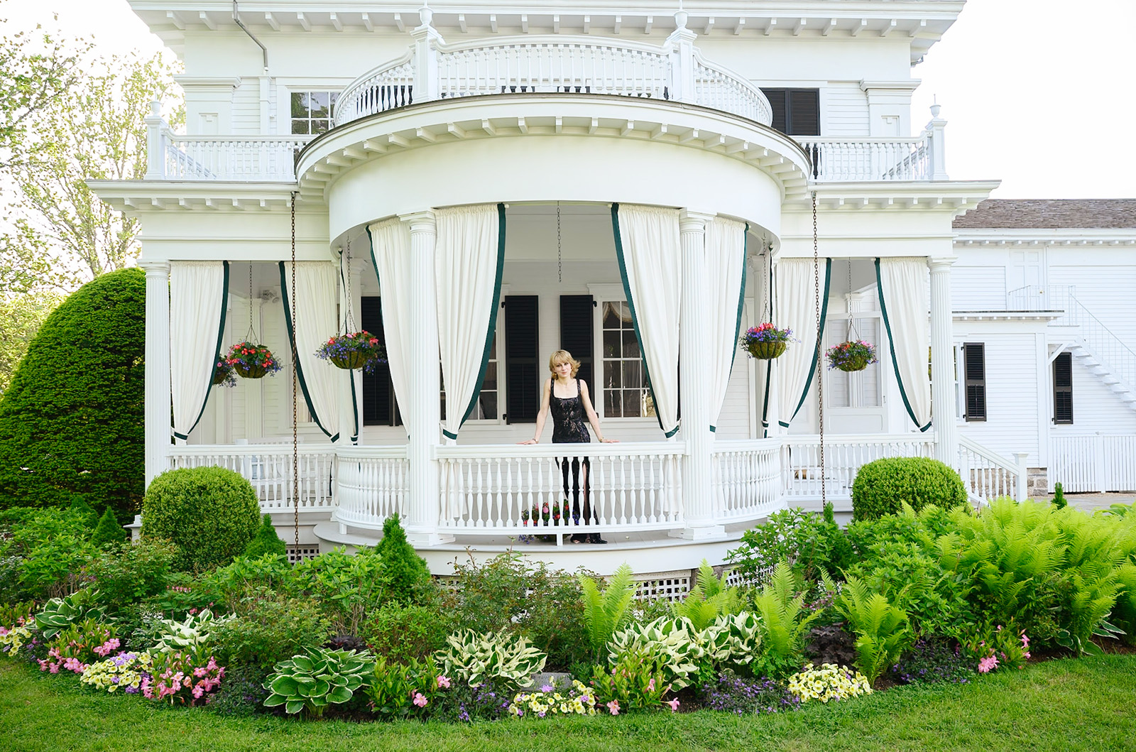Lillie Cabral models on the porch of the Fisher house.