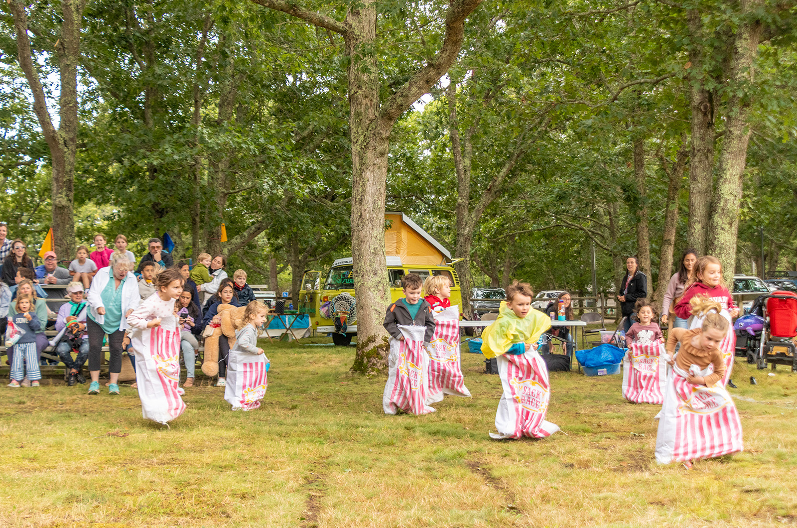 Kids run the sack race.