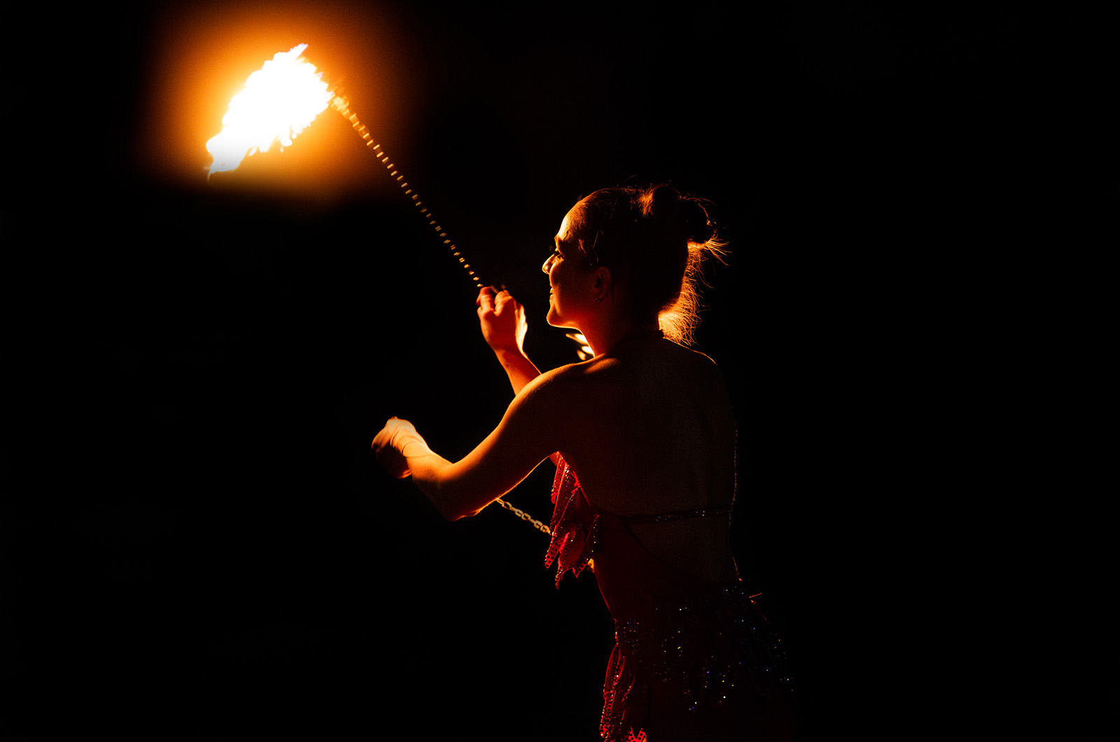 After dark, Miss Molly Dazzle lights up the night with her fire show.