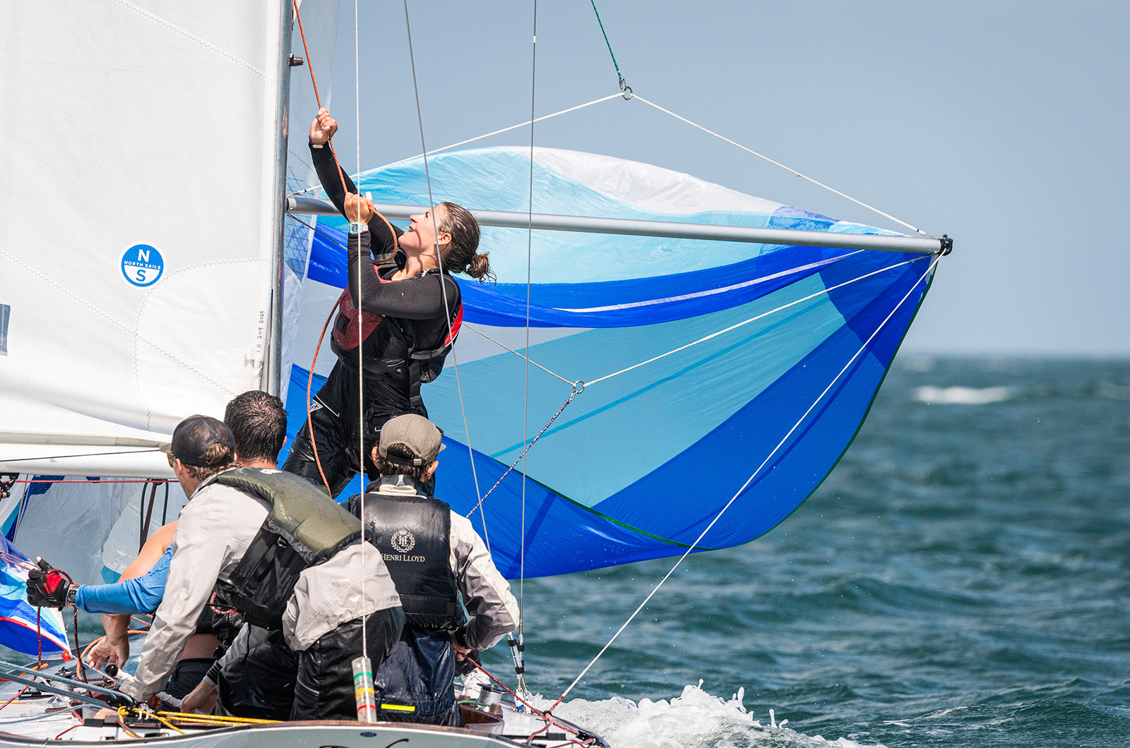 Sailors aboard Robin getting the spinnaker up.