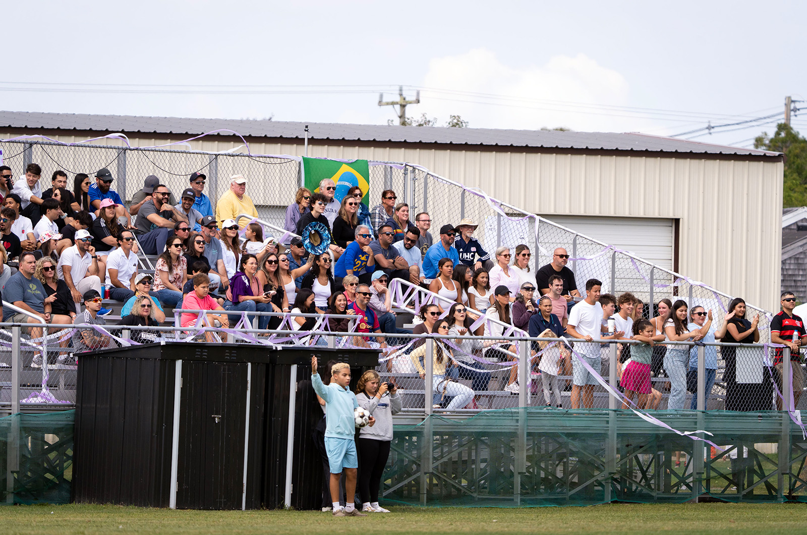 The crowd shows their support fro the Vineyard side.