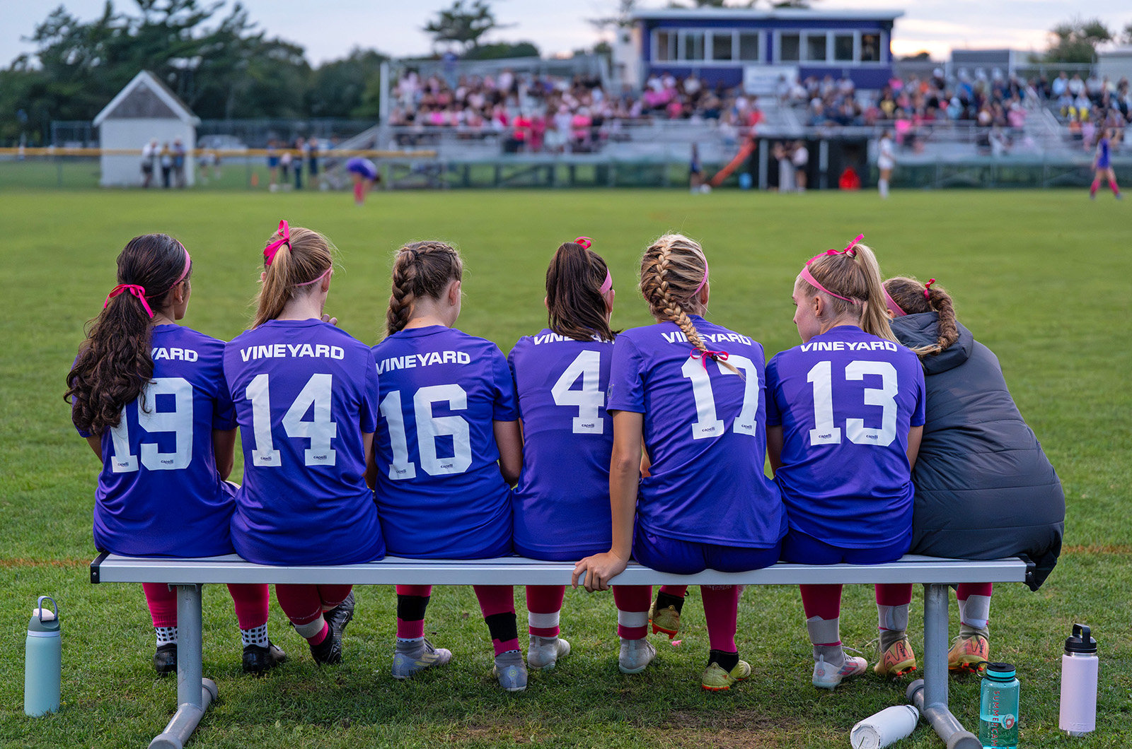 The MVRHS girls soccer team waiting on the bench.