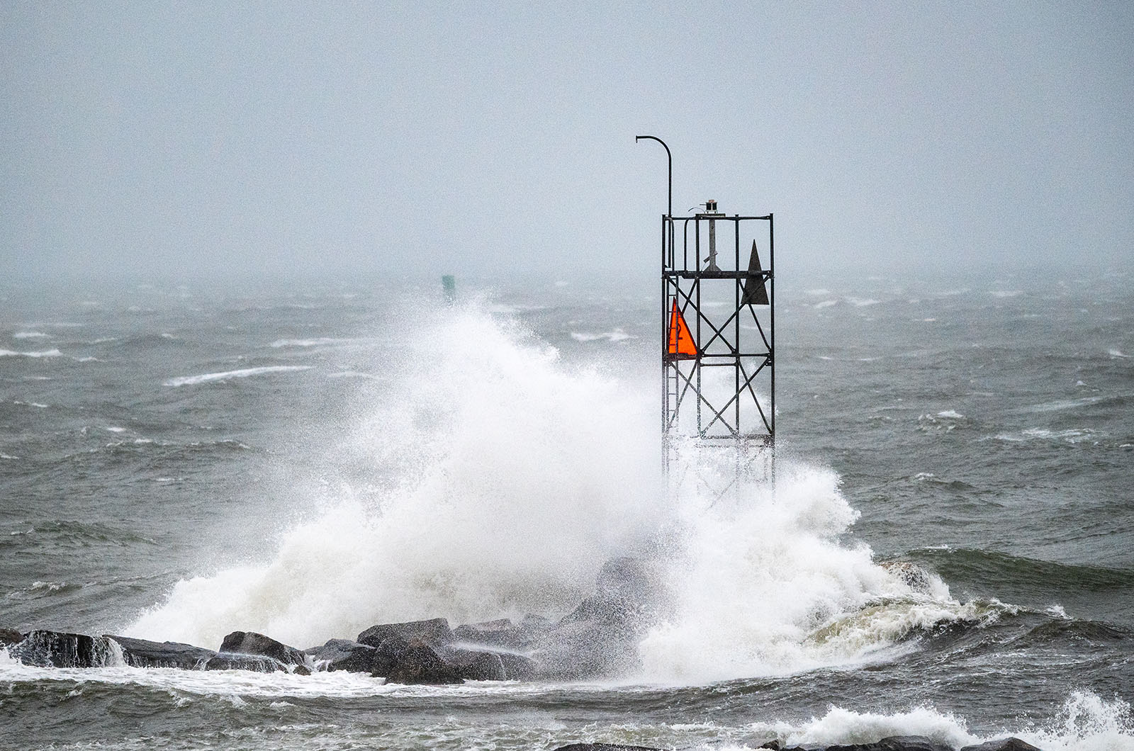 Wave breaks on Oak Bluffs harbor jetty.