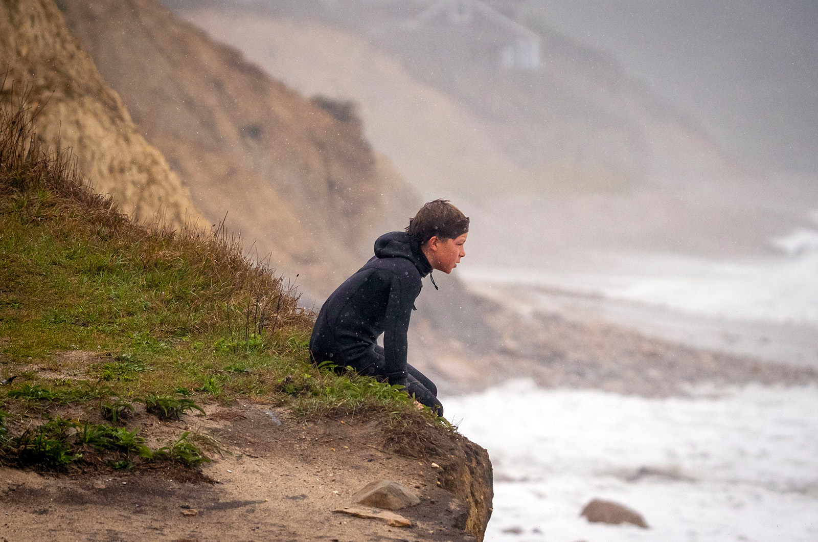 A young surfer watches waves roll in at Squibnocket.