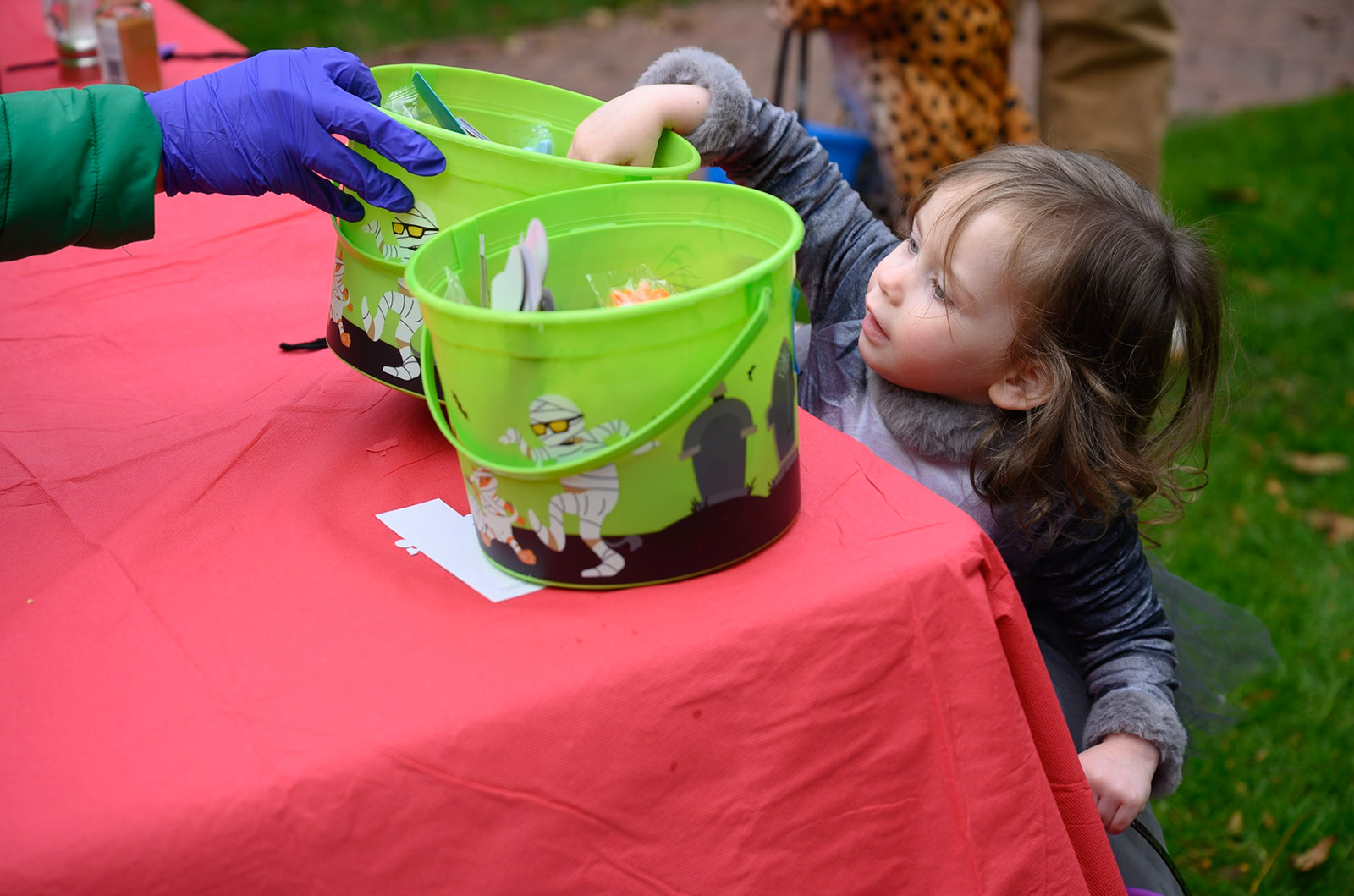 Reaching for one more piece of candy.