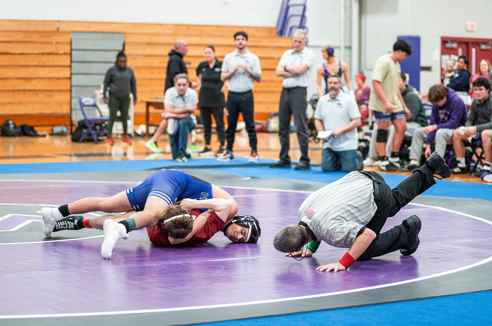 The referee watches for the pin.
