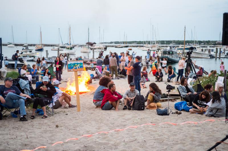 Crowds begin gathering on the beach as the evening goes on.