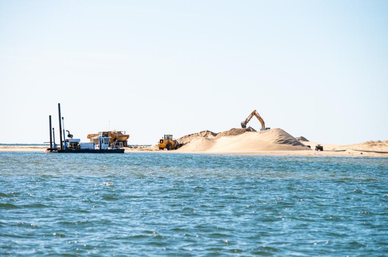 Dredge and excavation equipment seen from the pond.