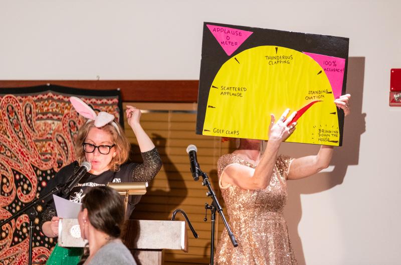 Molly Coogan and Abby Bender demonstrating the Applause-O-Meter.