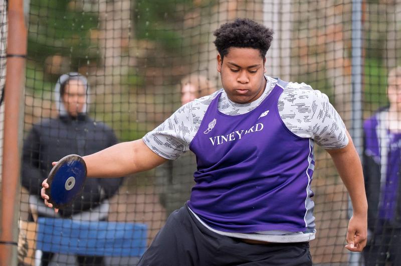 Vineyard athlete throwing the discus.