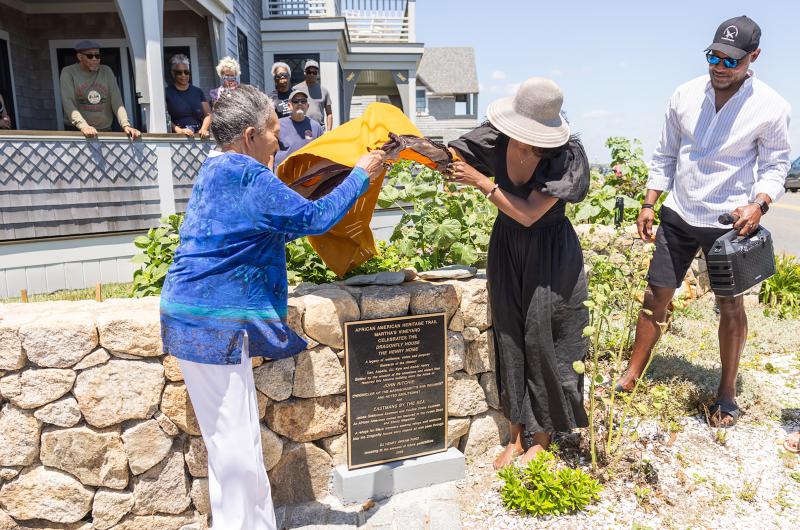 Barbara Eastman and Amber Henry unveil the new plaque at the Dragonfly House for the African American Heritage Trail.