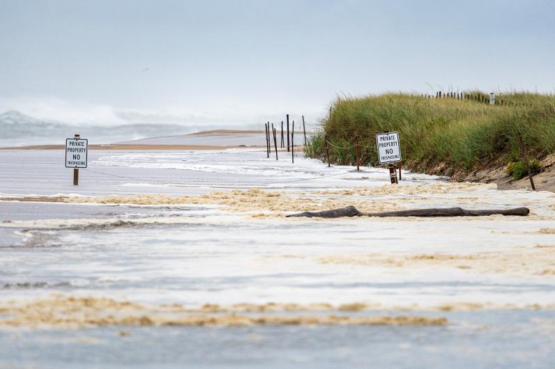 Heavy surf floods onto beach.