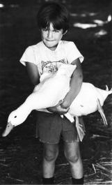 kid holding a goose