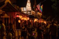 A gathering amid the lit lanterns.