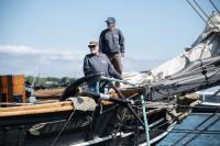 The crew works to secure the ship at the dock.