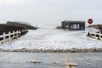 A wave rushes down Katama road from the left fork entrance to South Beach.
