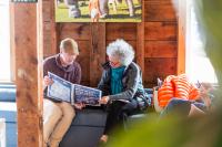 Brian Ditchfield (left) helps a guest with the festival schedule.