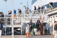 The ferry unloads its contents of passengers.