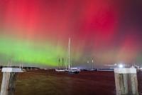 Tall ships in Vineyard Haven harbor under the northern lights.