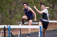 A Vineyard athlete clears a hurdle.