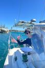 Enrica Jossi at the helm leaving Hatchet Bay in the Bahamas.