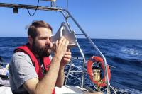 Josh Kegan navigating with a sextant.