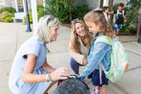 Edgartown School's new principal Kate Campbell introduces students to Shae, the therapy dog.