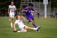 Kenny Martinez (right) avoids a slide tackle.
