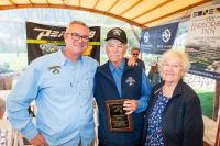 John Custer shares an award with Cooper and Lela Gilkes.
