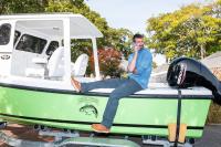 Sam makes a call from his new boat.