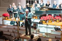 Chorus director William Peek introduces a piece.